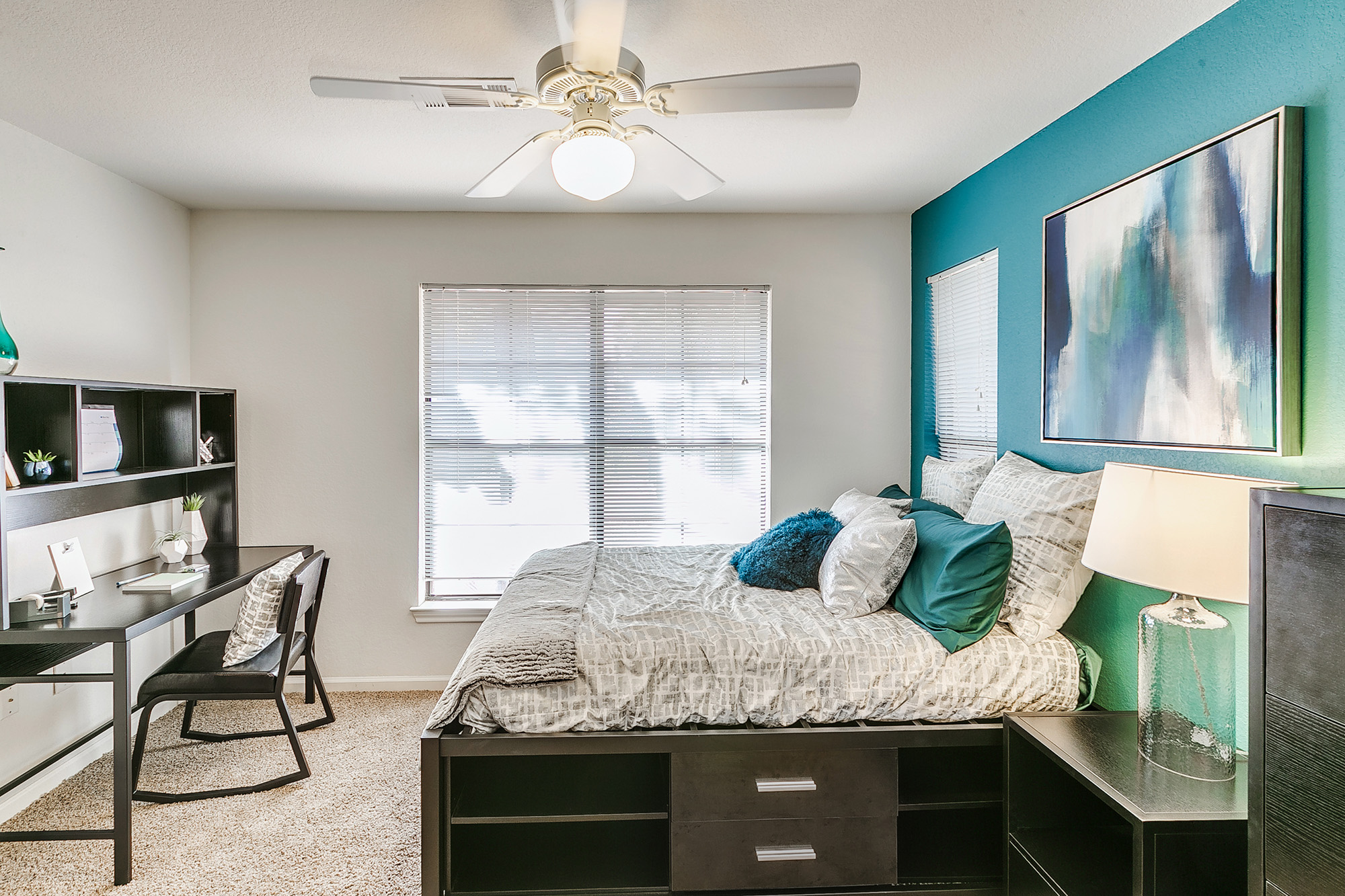 a bedroom with a desk and a computer