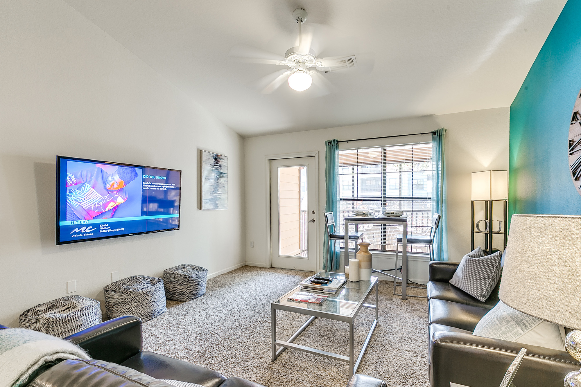 a living room with a television and a table