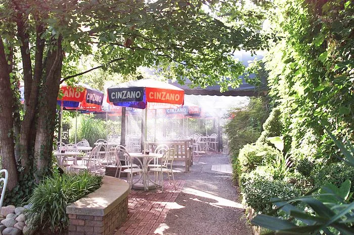 a patio with tables and chairs